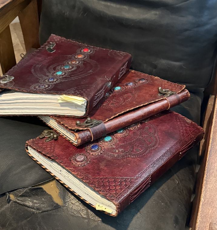 The three leather-bound notebooks of The Boly Hible, stacked